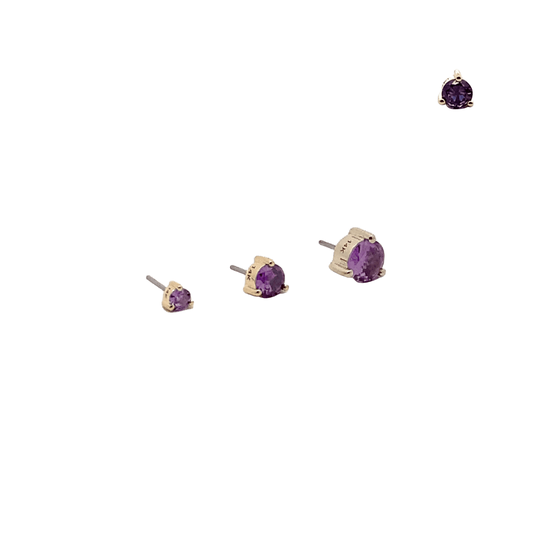 Set of amethyst gemstone earrings on a black background