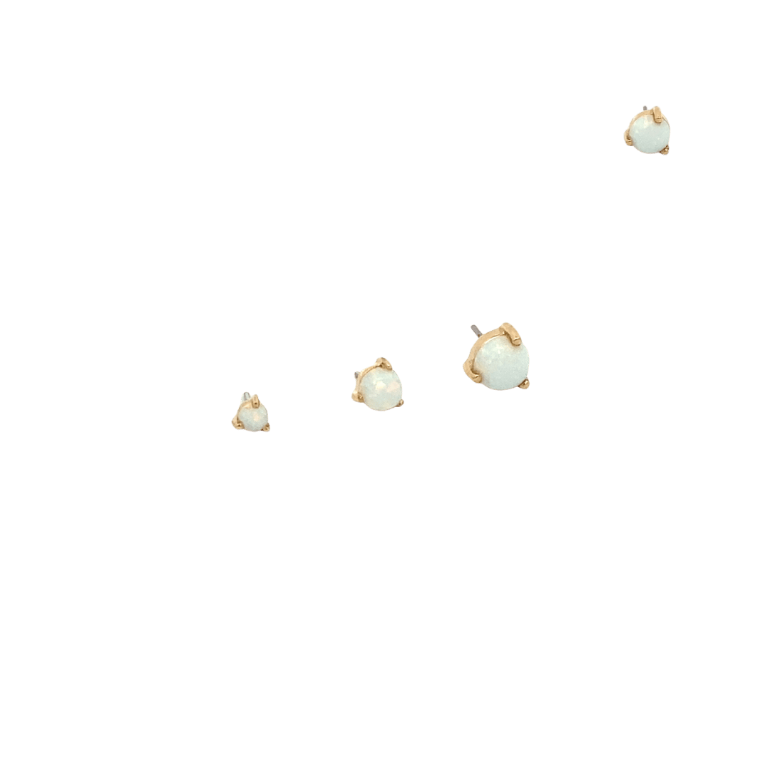 Set of gold earrings with opal stones on a black background