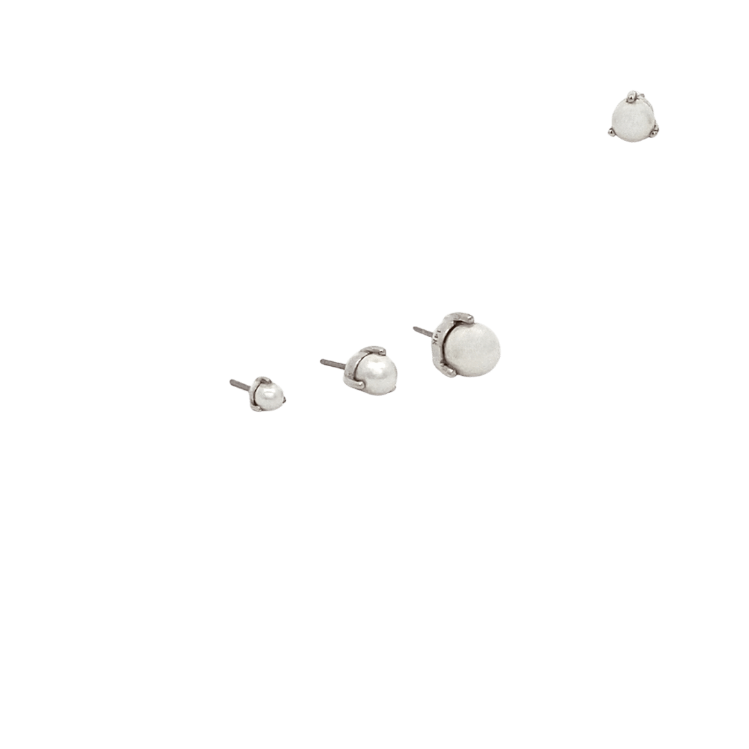 Set of silver stud earrings on a black background