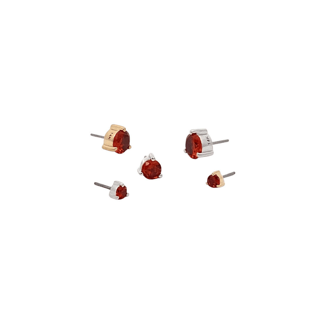 Set of small earrings with ruby birthstones on a black background