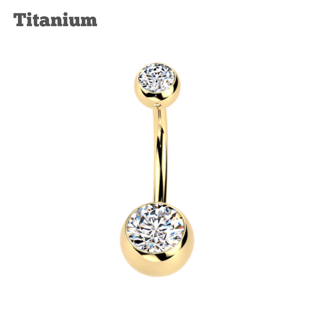 Gold belly button ring with clear gemstones on a black background