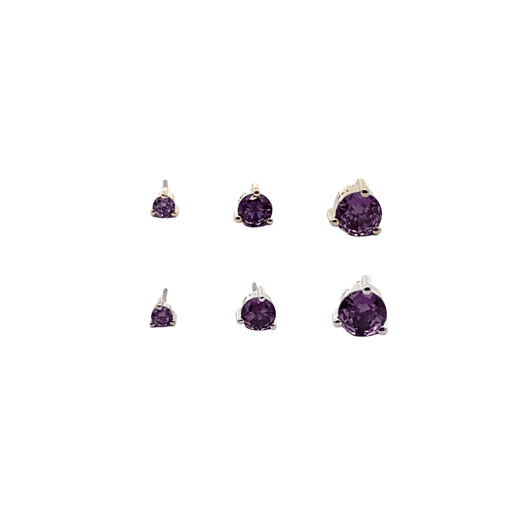 Set of amethyst birthstone earrings on a black background