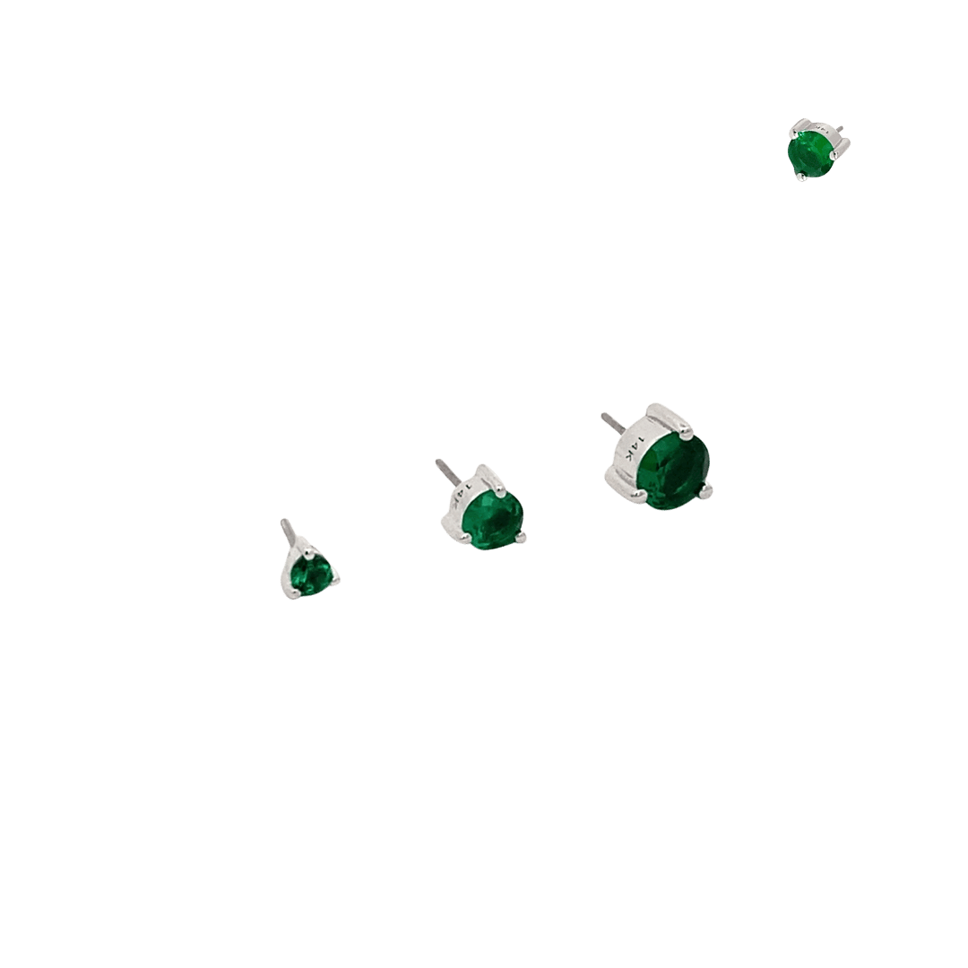 Set of green gemstone earrings on a black background