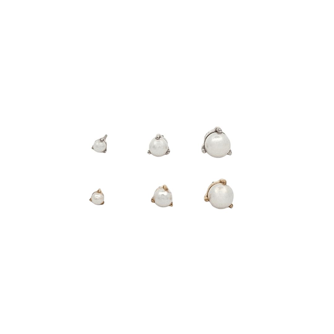 Set of pearl earrings on a black background