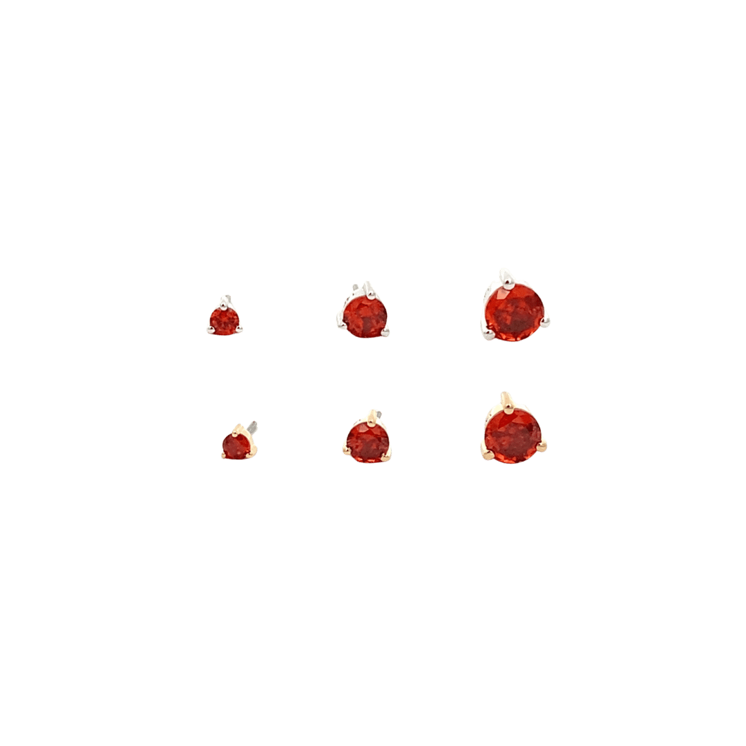 Set of six red gemstone earrings on a black background