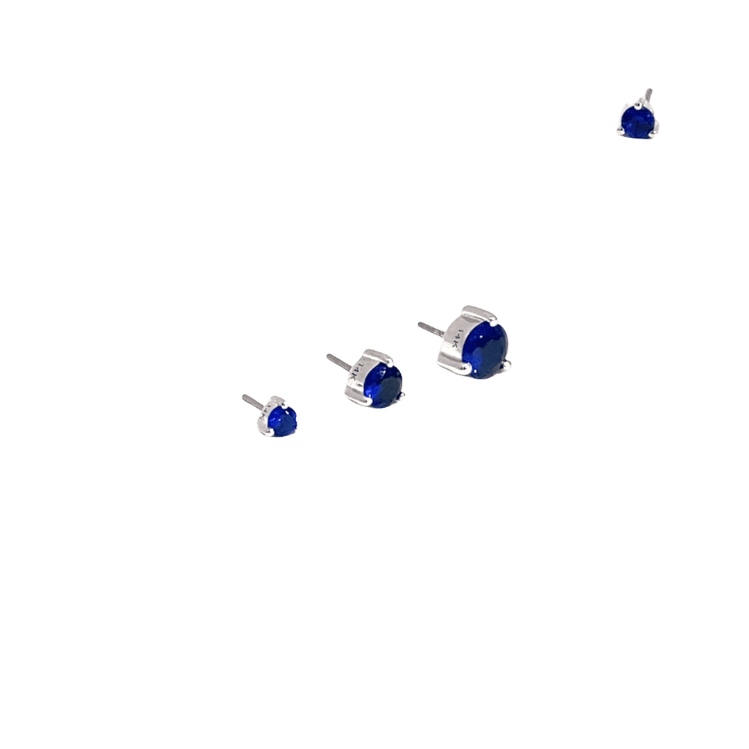 Set of sapphire gemstone stud earrings on a black background