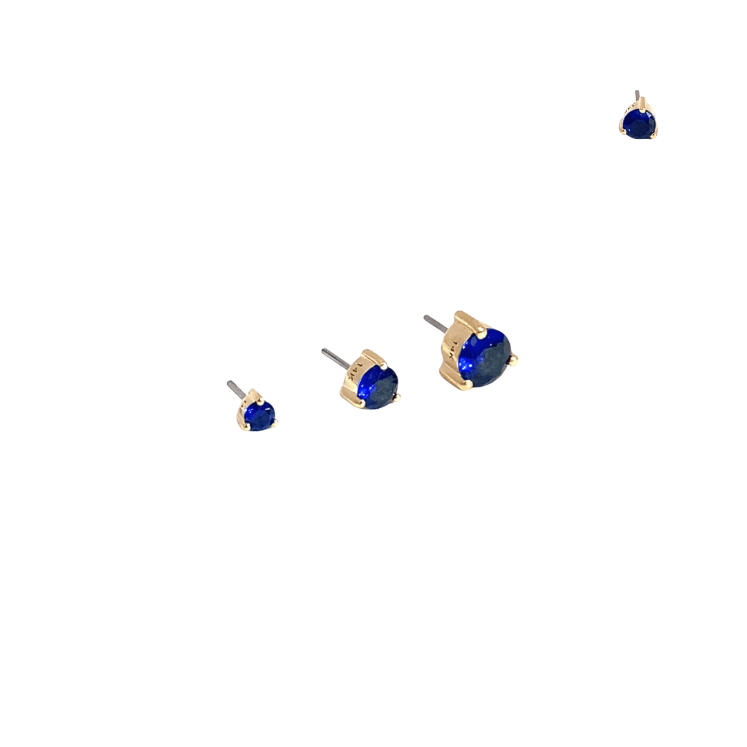 Set of gold and blue stud earrings on a black background