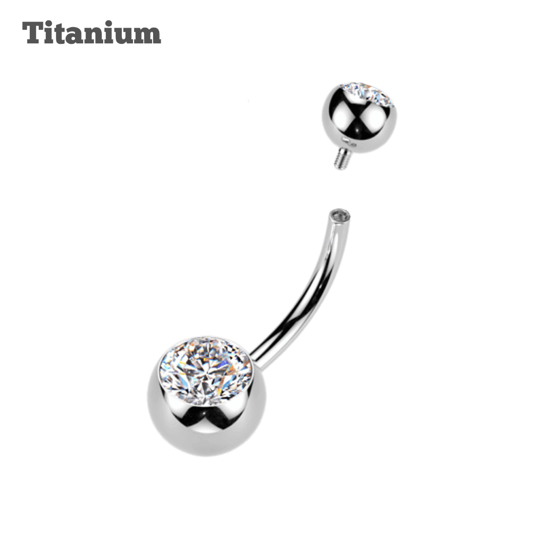 Silver belly button ring with clear gemstone on a black background, labeled 'Titanium'.