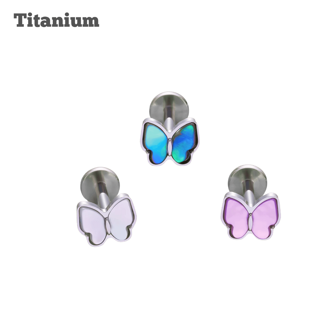 Butterfly-shaped earrings in blue, white, and pink on a black background with 'Titanium' text.